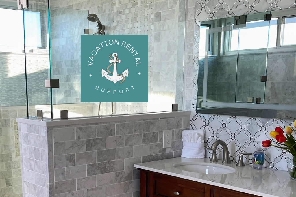 Hand towel with a fan-folded washcloth neatly placed on a bathroom countertop near the sink, with a soap dispenser positioned in front for a clean and organized vacation rental setup.